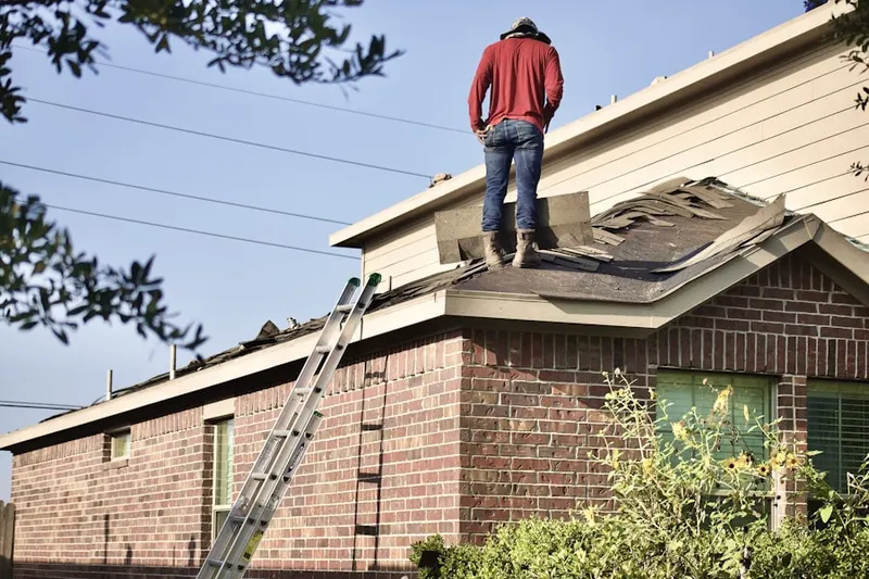 Professional roofer working on a residential roof in Dyerstown